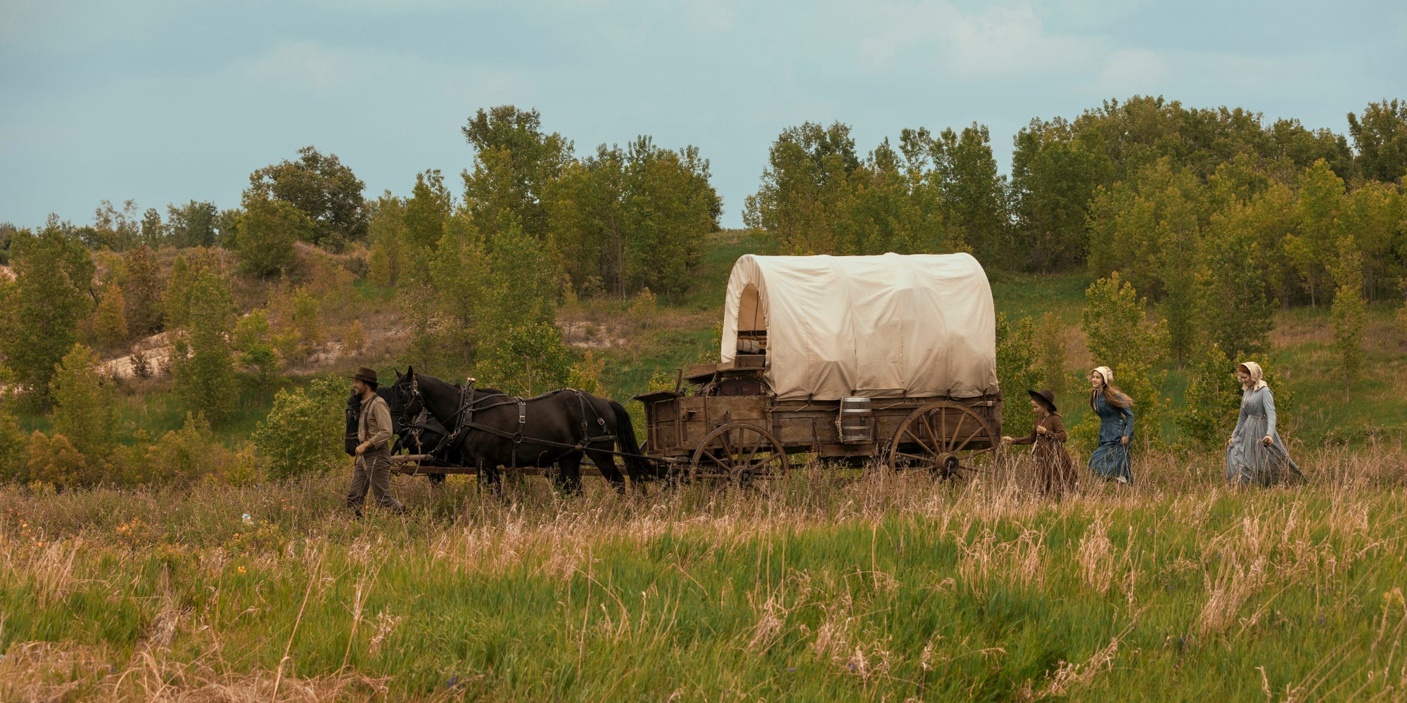 Luke Bracey (Charles Ingalls), Alice Halsey (Laura Ingalls), Skywalker Hughes (Mary Ingalls) et Crosby Fitzgerald (Caroline Ingalls) dans le premier épisode de "La Petite Maison dans la prairie" sur Netflix. 