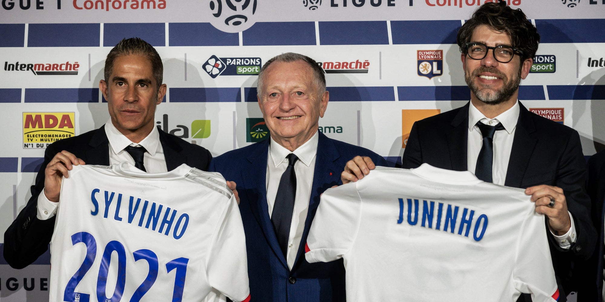 Le président de l'OL, Jean-Michel Aulas, entouré de Sylvinho et Juninho lors de leur arrivé, le 28 mai 2019.
